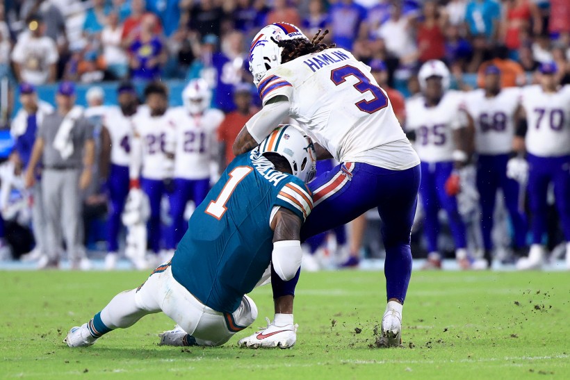 Tua Tagovailoa #1 of the Miami Dolphins collides with Damar Hamlin #3 of the Buffalo Bills during the third quarter in the game at Hard Rock Stadium on September 12, 2024 in Miami Gardens, Florida.