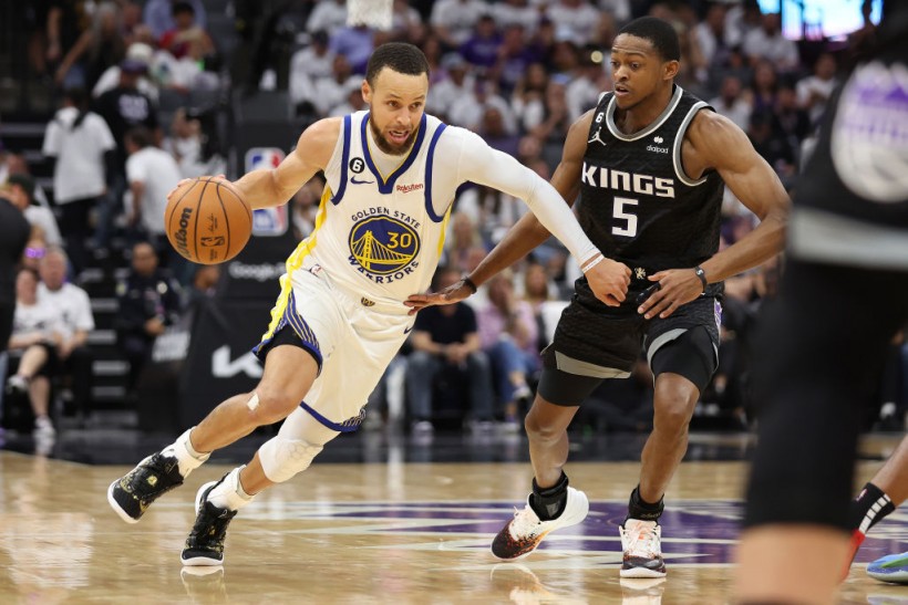 Stephen Curry and De'Aaron Fox - Golden State Warriors v Sacramento Kings - Game Seven