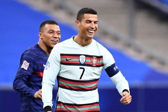 Kylian Mbappe and Cristiano Ronaldo - TOPSHOT-FBL-EUR-NATIONS-FRA-POR